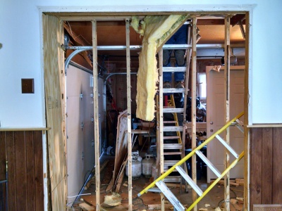 Removal of old built in entertainment center and framing out open for new service door